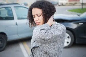 young woman holding her neck due too an auto accident injury 