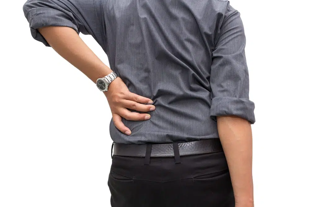 man holding his lower back due too pain