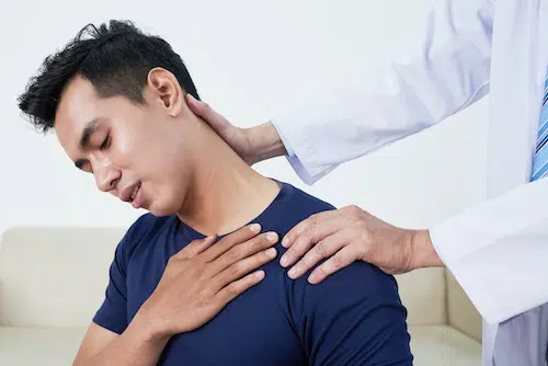 doctor stretching young male patients neck