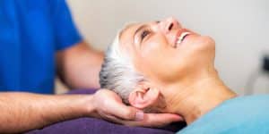 chiropractor massaging patients head