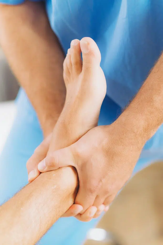 chiropractor adjusting patients foot