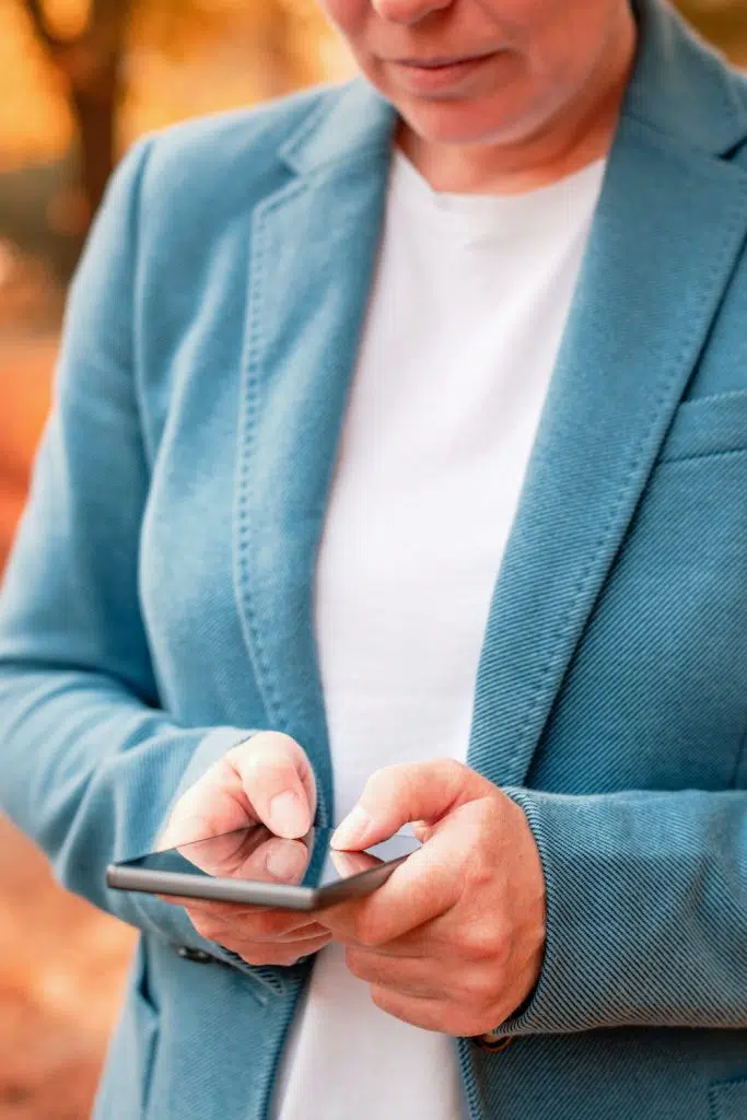 middle aged woman looking at her cellphone