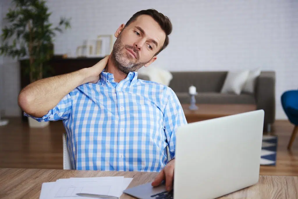 man holding his neck due to pain