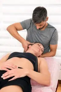 chiropractor adjusting patients neck