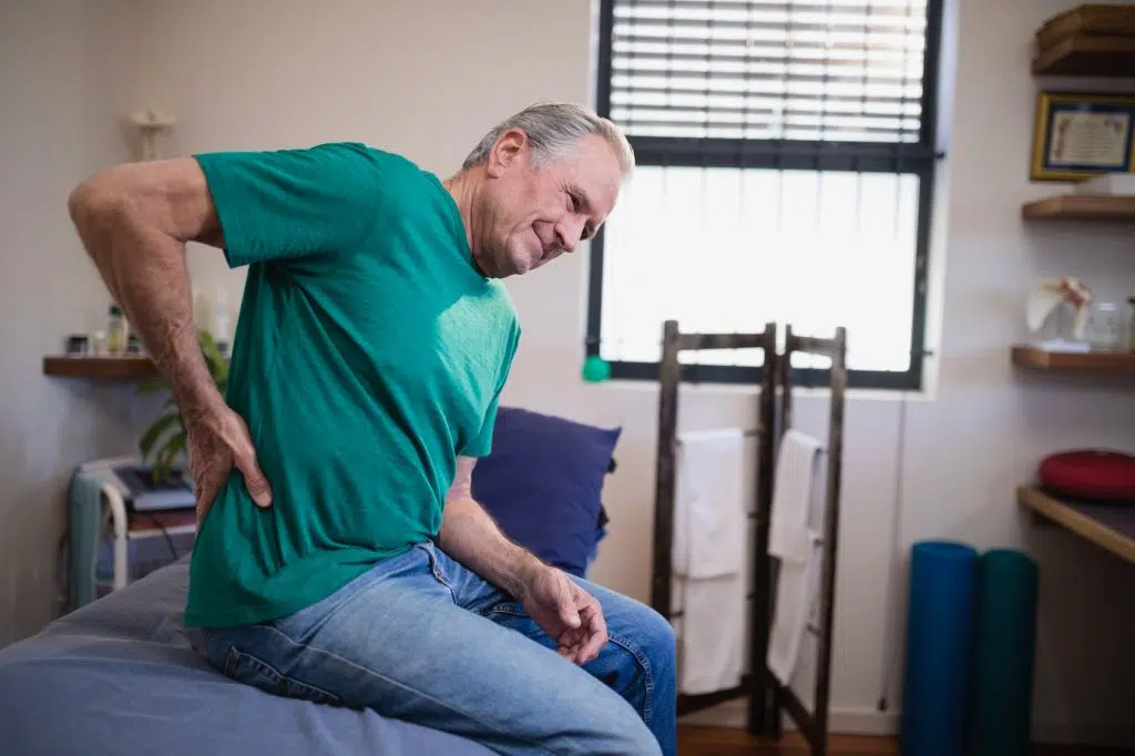 elderly man having back and hip pain