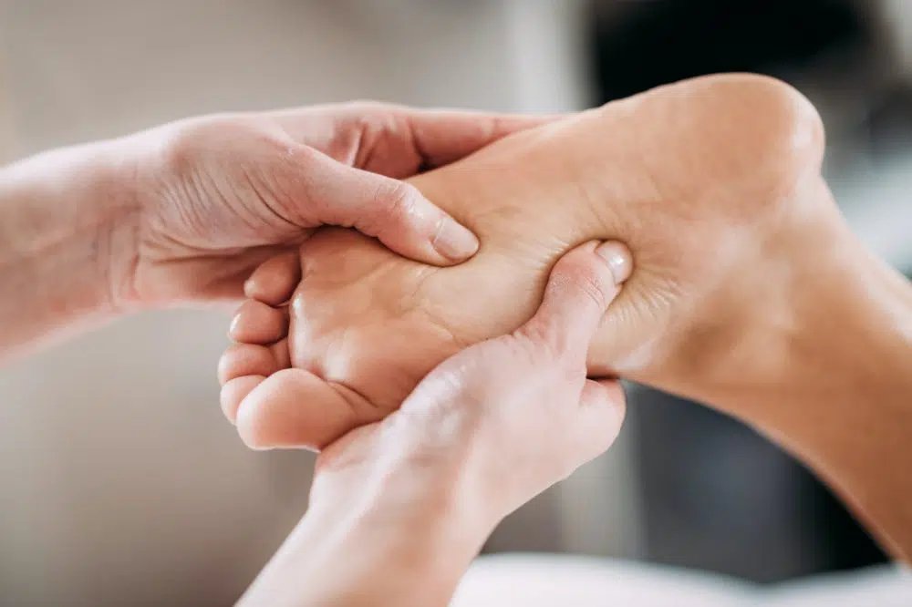 therapist massaging patients foot