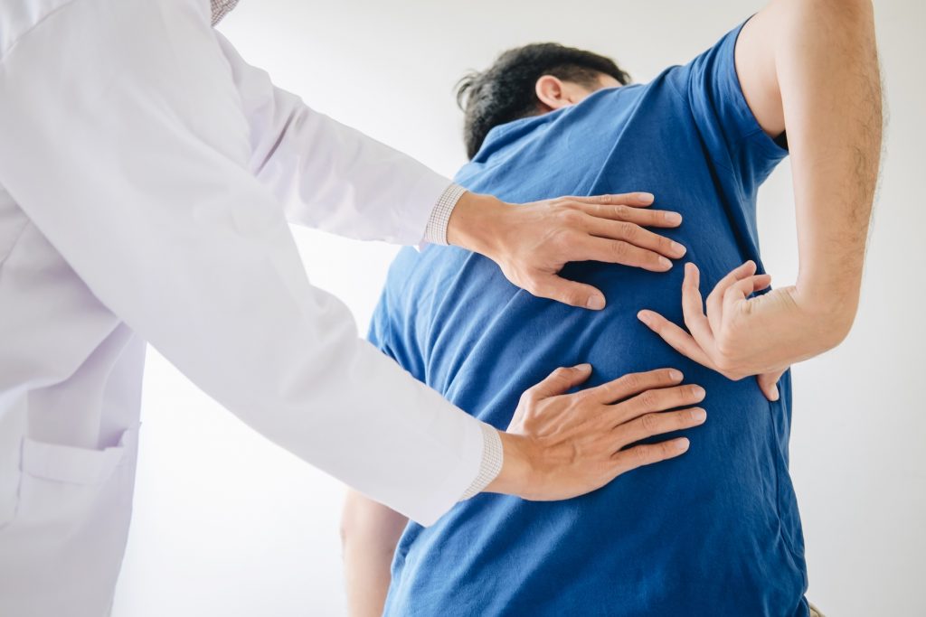 Chiropractor helping a patient with a pinched nerve