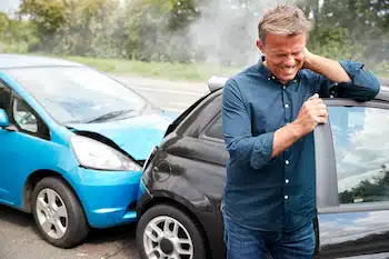 Male Driver With Whiplash Injury In Car Crash After Getting Out Of His Vehicle