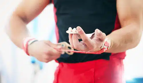 gymnast with Sprains and Strains applying bandage after personal unjury