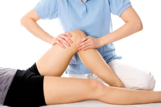 Chiropractor helping the patient's knee injury